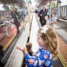 An excited young passenger at Sunbury station waves at those on the first service towards the Metro Tunnel in November.