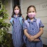Grace and Sarah wear masks to school in 2021.
