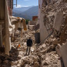 A man walks among the rubble in the town of Moulay Brahim in the High Atlas Mountains.