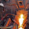 A worker taps into the copper stream at BHP’s Olympic Dam.