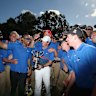 Rory McIlroy of Northern Ireland poses with the Australian Open trophy and greenkeeping staff.