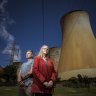 Latrobe Valley residents Wendy Farmer and Tony Wolfe, pictured near the Yallourn Power Plant, advocate for transition away from fossil fuels to renewable energy.