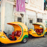 Yellow coco-taxis parked at a street of Havana.
