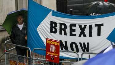 Demonstrators hold a "Brexit Now" banner outside the Supreme Court in London.
