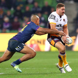 Brenko Lee is tackled by Felise Kaufusi of the Storm during the round 15 Brisbane-Melbourne match at AAMI Park.
