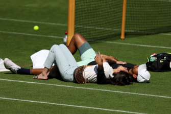 Nick Kyrgios and his girlfriend Costeen Hatzi lay together on the practice courts of Wimbledon.
