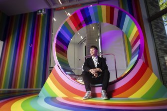 Melbourne University Science Gallery director Ryan Jefferies sitting on Wheel, by Hiromi Tango and Dr Emma Burrows. 