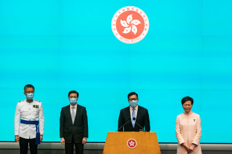 John Lee (centre), with Hong Kong Chief Executive Carrie Lam. 