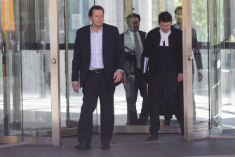 Mark Elliott (left) and Michael Symons (in robes) leave court in 2019.