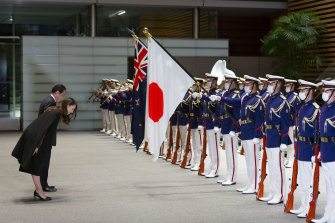NZ PM Jacinda Ardern, left, and her Japanese counterpart, Fumio Kishida, bow as they inspect an honour guard during a welcome ceremony in Tokyo.