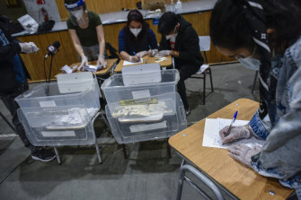 Electoral officers tally votes in Santiago during Sunday's constitutional referendum.