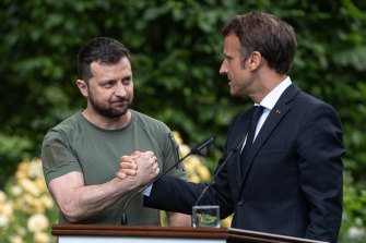 Ukrainian President Volodymyr Zelensky and French President Emmanuel Macron shake hands after a press conference in Kyiv on June 16.