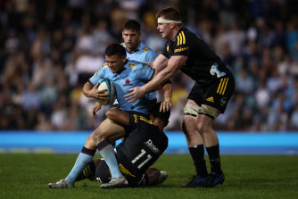 Izaia Perese is tackled against the Hurricanes at Leichhardt Oval.