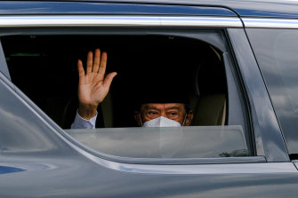 Mlaysian Prime Minister Muhyiddin Yassin waves as he arrives the royal palace in Kuala Lumpur on Monday.
