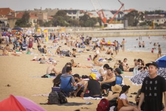 Crowds enjoy the sun at St Kilda beach on Australia Day 2022.