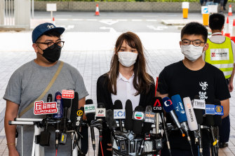 From left, pro-democracy activist Ivan Lam Long-yin, Agnes Chow Ting and Joshua Wong speak outside court in Hong Kong after their new illegal assembly charges.
