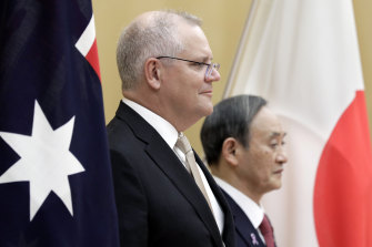The Chinese Foreign Minister could meet with new Japan Prime Minister Yoshihide Suga (right), who has been carefully nurturing bilateral relations with a number of countries, including Australia, since he came to power in September. 