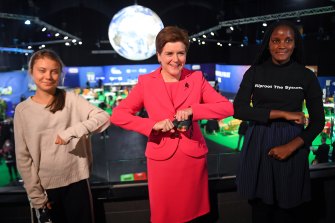 Greta Thunberg poses with Scotland’s First Minister Nicola Sturgeon (C) and fellow climate activist Vanessa Nakate (R) on Monday, November 1 at the COP26 conference in Glasgow. 