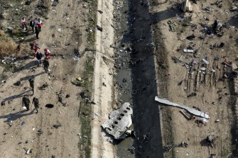 Rescue workers searching the scene where a Ukrainian plane crashed in Shahedshahr, southwest of Tehran.