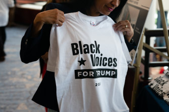 An attendee holds a "Black Voices for Trump" shirt before a campaign event for US President Donald Trump in Atlanta, Georgia last month.
