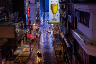 Pedestrians walk along the near deserted Lan Kwai Fong district on Hong Kong island in 2020. 