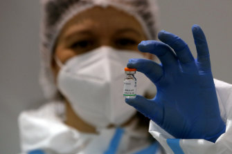 A medical worker poses with a vial of the Sinopharm’s COVID-19 vaccine in Serbia.