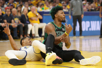 Marcus Smart and Jordan Poole get in a tangle.