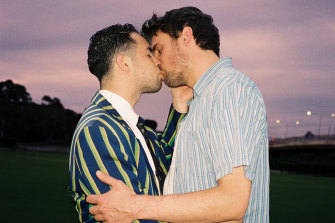 James Robinson kissing his partner Vishnu Hazell on the school grounds.