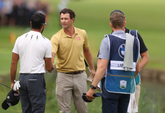Adam Scott and Francesco Laporta shake hands on the 18th green after completing their rounds at Wentworth.