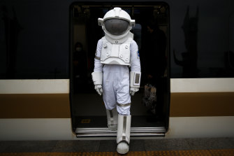 A man dressed as an astronaut steps off a train in Istanbul, Turkey, as part of a campaign to promote a NASA Space Exhibition in December.