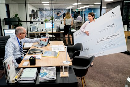 Rob Sitch in Utopia comes to grips with decluttering the office ... of giant novelty cheques.
