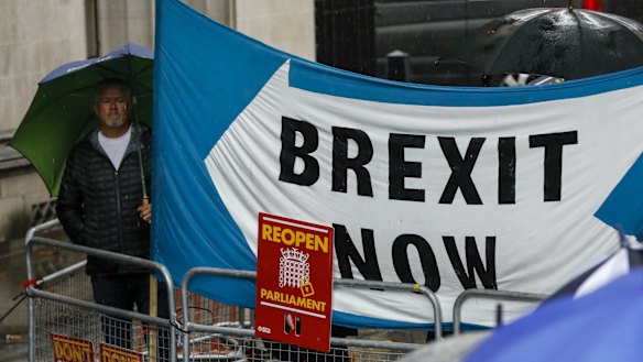 Demonstrators hold a "Brexit Now" banner outside the Supreme Court in London.