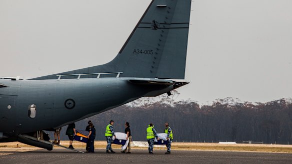 The precious cargo are loaded onto a military plane bound for Melbourne.