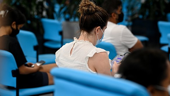 People wait after getting their vaccinations at the South Western Sydney Vaccination Centre on Wednesday.