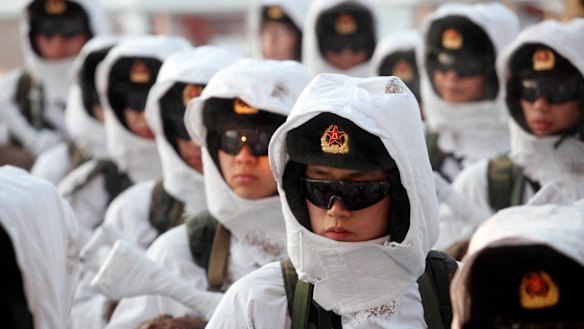 The report warned that China's army, pictured here during a winter training drill in 2016, could defeat the US.