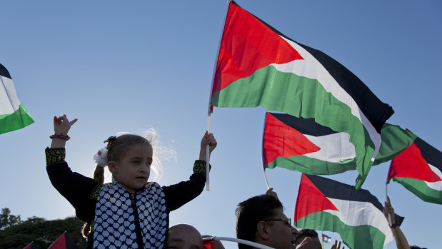 Protesters fly Palestinian flags during a rally in the West Bank Bedouin community of Khan al-Ahmar.