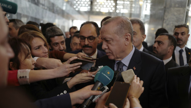 Turkish President Recep Tayyip Erdogan speaks to the media at the parliament in Ankara.