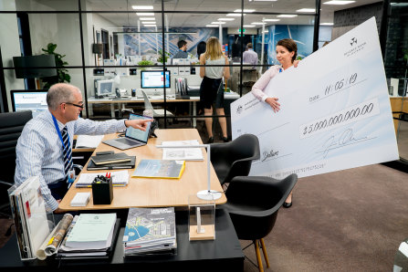 Rob Sitch in Utopia comes to grips with decluttering the office ... of giant novelty cheques.
