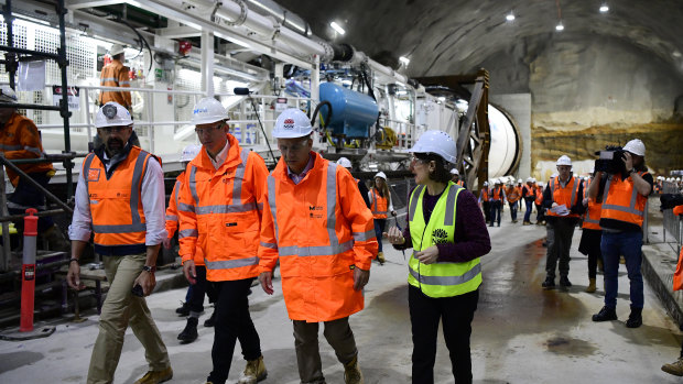 Transport Minister Andrew Constance, third from left, and Premier Gladys Berejiklian inspect the boring machine at Barangaroo.
