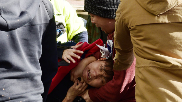 Pro-China and pro-democracy protesters clash at a rally in Sydney.