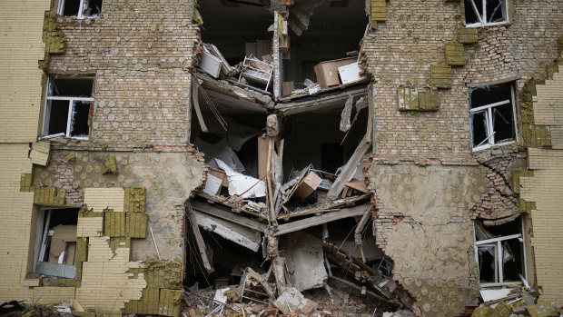 Debris hangs from a residential building heavily damaged in a Russian bombing in Bakhmut, eastern Ukraine.