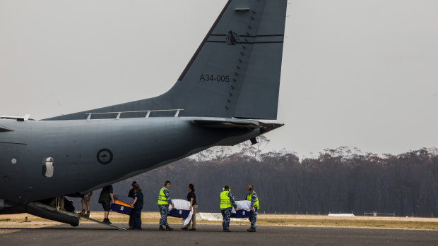 The precious cargo are loaded onto a military plane bound for Melbourne.