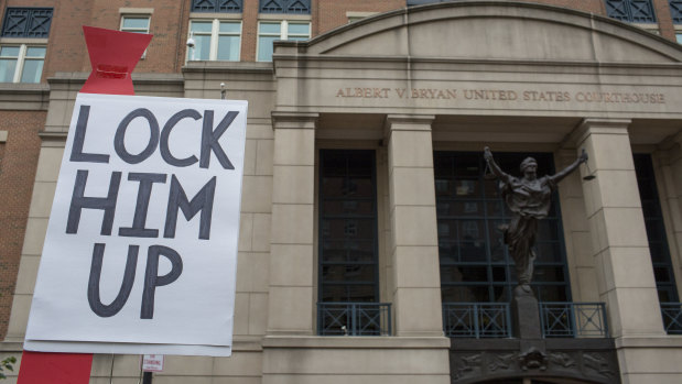 A demonstrator holds a "Lock Him Up" sign before the trial of former Trump Campaign Manger Paul Manafort outside of District Court in Alexandria, Virginia, US.