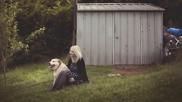 Bec with Goldie the Labrador in 2013. The pair sheltered together in a bathtub when the Black Saturday fires hit Kinglake.