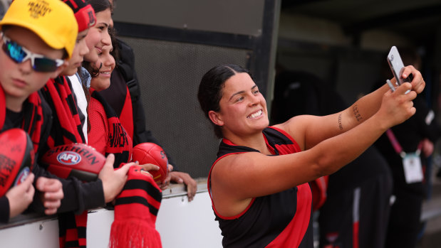 Maddy Prespakis takes a selfie with Bombers fans after Essendon’s win over St Kilda.