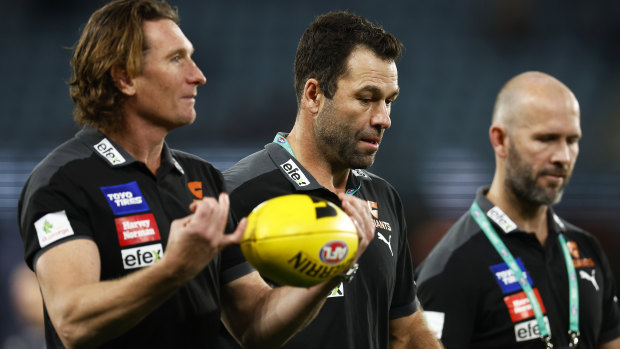 James Hird and Dean Solomon speak with then Giants interim coach Mark McVeigh during the 2022 season.