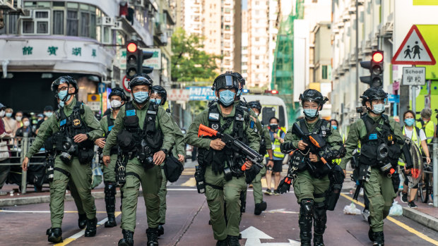 Riot police in Hong Kong head toward an anti-government protest on September 6.