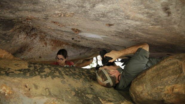 Researchers Sam Harper and Damien Finch record the 17,300-year-old painting of a kangaroo.