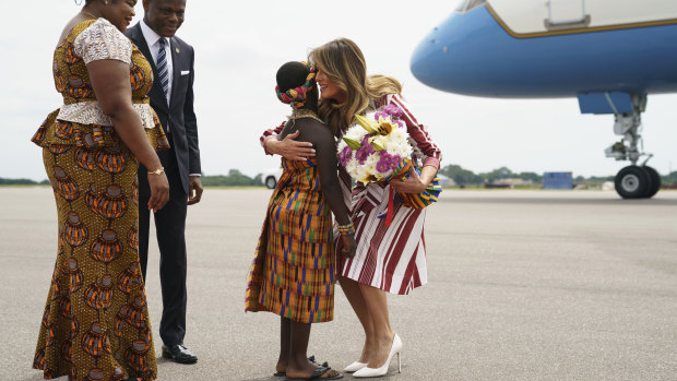 Melania Trump embraces flower girl Lillian Naa Adai Sai, 8, at Kotoka International Airport in Accra, Ghana.