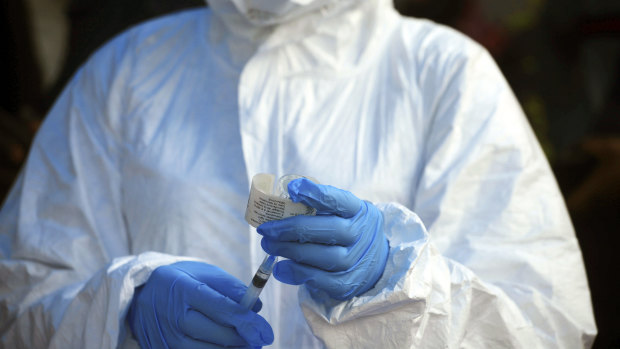 A health-care worker from the World Health Organisation prepares to give an Ebola vaccination in Mangina, Democratic Republic of Congo.